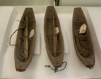 Ainu. <em>Long, Narrow Toy Canoe</em>. Wood, 1 15/16 x 12 5/8 in. (5 x 32 cm). Brooklyn Museum, Gift of Herman Stutzer, 12.134b. Creative Commons-BY (Photo: , CUR.12.134a-c_group.jpeg)