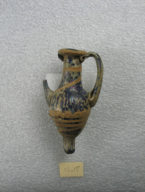  <em>Amphora</em>, 5th century B.C.E. Glass, 3 5/16 x 1 3/4 in. (8.4 x 4.5 cm). Brooklyn Museum, Purchased with funds given by Robert B. Woodward, 12.15. Creative Commons-BY (Photo: Brooklyn Museum, CUR.12.15_side2.jpg)