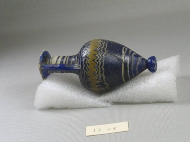  <em>Amphora</em>, 5th century B.C.E. Glass, 4 5/16 x Diam. 2 in. (10.9 x 5.1 cm). Brooklyn Museum, Purchased with funds given by Robert B. Woodward, 12.28. Creative Commons-BY (Photo: Brooklyn Museum, CUR.12.28_side_view2.jpg)