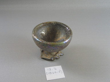 Roman. <em>Trick Bottle with Added Foot</em>, 1st century C.E. Glass, 2 7/16 x Diam. 2 7/8 in. (6.2 x 7.3 cm). Brooklyn Museum, Gift of Aziz Khayat, 12.3. Creative Commons-BY (Photo: Brooklyn Museum, CUR.12.3.jpg)