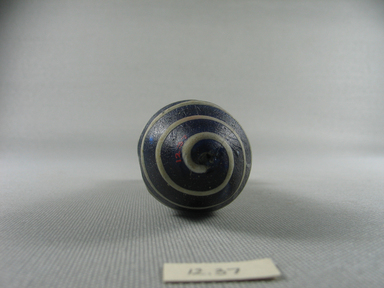  <em>Alabastron</em>, mid 4th-late 3rd centery B.C.E. Glass, 4 3/4 × Diam. 1 9/16 in. (12 × 3.9 cm). Brooklyn Museum, Purchased with funds given by Robert B. Woodward, 12.37. Creative Commons-BY (Photo: Brooklyn Museum, CUR.12.37_bottom.jpg)