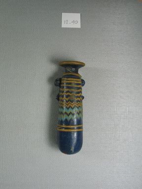  <em>Cylindrical Alabastron</em>, late 6th-early 4th century B.C.E. Glass, 3 11/16 × Diam. 1 1/16 in. (9.4 × 2.7 cm). Brooklyn Museum, Purchased with funds given by Robert B. Woodward, 12.40. Creative Commons-BY (Photo: Brooklyn Museum, CUR.12.40_side.jpg)