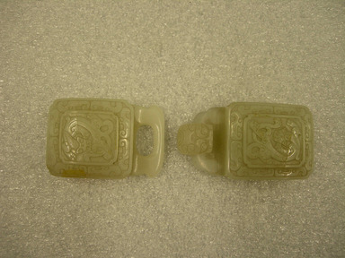  <em>Buckle Consisting of Two Convex Pieces</em>, 18th century. White jade, 11/16 x 1 5/8 x 4 3/4 in. (1.8 x 4.2 x 12 cm). Brooklyn Museum, Bequest of Robert B. Woodward, 14.273a-b. Creative Commons-BY (Photo: Brooklyn Museum, CUR.14.273a-b_front.jpg)