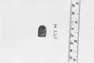  <em>Stela-Shaped Plaque Amulet of Amunhotep III</em>, ca. 1539-1292 B.C.E. Steatite, glaze, 1/4 x 7/16 x 5/8 in. (0.7 x 1.1 x 1.6 cm). Brooklyn Museum, Gift of the Egypt Exploration Fund, 14.628. Creative Commons-BY (Photo: Brooklyn Museum, CUR.14.628_NegA_print_bw.jpg)