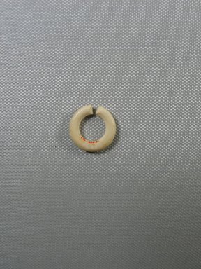  <em>Circular Earring</em>, ca. 1539-1292 B.C.E. Limestone, 3/16 × Diam. 7/8 in. (0.5 × 2.2 cm). Brooklyn Museum, Gift of the Egypt Exploration Fund, 14.646. Creative Commons-BY (Photo: Brooklyn Museum, CUR.14.646_view.1.jpg)