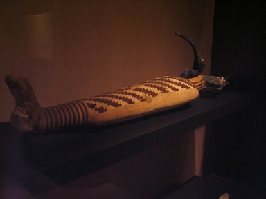  <em>Ibis Mummy</em>, 30 B.C.E.–100 C.E. Animal remains, resin, linen, Ibis mummy with headdress: 30 5/16 x 5 1/2 x 8 1/4 in. (77 x 14 x 21 cm). Brooklyn Museum, Gift of the Egypt Exploration Fund, 14.655a-b. Creative Commons-BY (Photo: Brooklyn Museum, CUR.14.655_mummychamber.jpg)