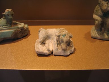  <em>Reclining Dog</em>, ca. 1938-1700 B.C.E. Faience, 13/16 x 1 15/16 x 1 1/2 in. (2 x 4.9 x 3.8 cm). Brooklyn Museum, Museum Collection Fund, 14.659. Creative Commons-BY (Photo: Brooklyn Museum, CUR.14.659_view1_erg2.jpg)