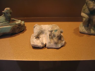  <em>Reclining Dog</em>, ca. 1938–1700 B.C.E. Faience, 13/16 x 1 15/16 x 1 1/2 in. (2 x 4.9 x 3.8 cm). Brooklyn Museum, Museum Collection Fund, 14.659. Creative Commons-BY (Photo: Brooklyn Museum, CUR.14.659_view1_erg2.jpg)