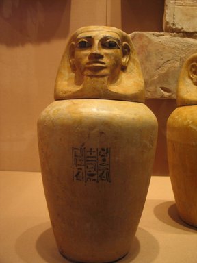  <em>Canopic Jar of Lady Senebtisi</em>, ca. 1938-1759 B.C.E. Limestone, pigment, 10 13/16 x 8 1/16 in. (27.5 x 20.5 cm). Brooklyn Museum, Museum Collection Fund, 14.665a-b. Creative Commons-BY (Photo: Brooklyn Museum, CUR.14.665a-b_mummychamber.jpg)