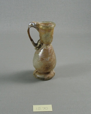 Roman. <em>Pitcher</em>, 1st-3rd century C.E. Glass, 3 1/4 x Diam. 1 3/8 in. (8.3 x 3.5 cm). Brooklyn Museum, Gift of R. B. Woodward, 15.70. Creative Commons-BY (Photo: Brooklyn Museum, CUR.15.70_view1.jpg)
