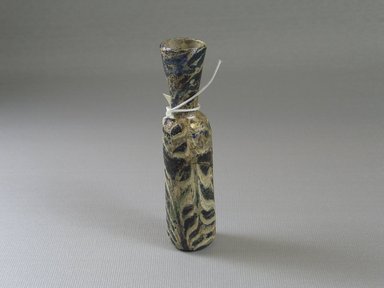 Islamic. <em>Bottle</em>, 8th-10th century C.E. Glass, 4 x greatest diam. 7/8 in. (10.1 x 2.3 cm). Brooklyn Museum, Bequest of Robert B. Woodward, 15.77. Creative Commons-BY (Photo: Brooklyn Museum, CUR.15.77_view2.jpg)