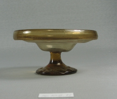 Egypto-Roman. <em>Bowl</em>, 4th century C.E. Glass, 2 1/16 x Diam. 4 3/16 in. (5.2 x 10.7 cm). Brooklyn Museum, Gift of Evangeline Wilbour Blashfield, Theodora Wilbour, and Victor Wilbour honoring the wishes of their mother, Charlotte Beebe Wilbour, as a memorial to their father, Charles Edwin Wilbour, 16.108.19. Creative Commons-BY (Photo: Brooklyn Museum, CUR.16.108.19_view2.jpg)