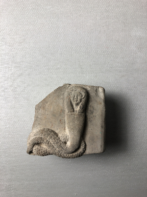  <em>Relief Fragment of a Human-headed Cobra</em>, 332 B.C.E.-100 C.E. Limestone (?), 2 5/16 × 2 9/16 × 1 5/8 in. (5.8 × 6.5 × 4.2 cm). Brooklyn Museum, Gift of Evangeline Wilbour Blashfield, Theodora Wilbour, and Victor Wilbour honoring the wishes of their mother, Charlotte Beebe Wilbour, as a memorial to their father, Charles Edwin Wilbour, 16.109. Creative Commons-BY (Photo: , CUR.16.109_view04.jpg)
