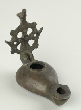 Coptic. <em>Lamp with Elaborate Handle</em>, 5th-6th century C.E. Bronze, 1 5/8 x 3 3/8 in. (4.2 x 8.6 cm). Brooklyn Museum, Gift of Evangeline Wilbour Blashfield, Theodora Wilbour, and Victor Wilbour honoring the wishes of their mother, Charlotte Beebe Wilbour, as a memorial to their father, Charles Edwin Wilbour, 16.133. Creative Commons-BY (Photo: Brooklyn Museum (in collaboration with Index of Christian Art, Princeton University), CUR.16.133_view3_ICA.jpg)