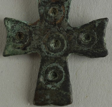 Coptic. <em>Cross Pendant</em>, 5th century C.E. Bronze, 5/8 × 1/16 × 1 in. (1.6 × 0.2 × 2.6 cm). Brooklyn Museum, Gift of Evangeline Wilbour Blashfield, Theodora Wilbour, and Victor Wilbour honoring the wishes of their mother, Charlotte Beebe Wilbour, as a memorial to their father, Charles Edwin Wilbour, 16.135. Creative Commons-BY (Photo: Brooklyn Museum (in collaboration with Index of Christian Art, Princeton University), CUR.16.135_detail01_ICA.jpg)