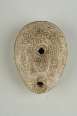 Coptic. <em>Lamp with Inscription on Base</em>, 5th–6th century C.E. Terracotta, 1 9/16 × 2 1/2 × 3 7/16 in. (4 × 6.3 × 8.8 cm). Brooklyn Museum, Gift of Evangeline Wilbour Blashfield, Theodora Wilbour, and Victor Wilbour honoring the wishes of their mother, Charlotte Beebe Wilbour, as a memorial to their father, Charles Edwin Wilbour, 16.153. Creative Commons-BY (Photo: Brooklyn Museum (in collaboration with Index of Christian Art, Princeton University), CUR.16.153_view1_ICA.jpg)