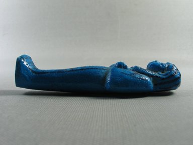  <em>Shabty of Pinodjem I</em>, ca. 1075-945 B.C.E. Faience, 4 1/8 × 1 3/8 in. (10.4 × 3.5 cm). Brooklyn Museum, Gift of Evangeline Wilbour Blashfield, Theodora Wilbour, and Victor Wilbour honoring the wishes of their mother, Charlotte Beebe Wilbour, as a memorial to their father, Charles Edwin Wilbour, 16.173. Creative Commons-BY (Photo: Brooklyn Museum, CUR.16.173_view03.jpg)