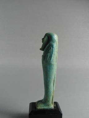  <em>Ushabti</em>, 664-332 B.C.E. Faience, 3 1/16 x 13/16 x 3/4 in. (7.8 x 2.1 x 1.9 cm). Brooklyn Museum, Gift of Evangeline Wilbour Blashfield, Theodora Wilbour, and Victor Wilbour honoring the wishes of their mother, Charlotte Beebe Wilbour, as a memorial to their father, Charles Edwin Wilbour, 16.178. Creative Commons-BY (Photo: Brooklyn Museum, CUR.16.178_view2.jpg)