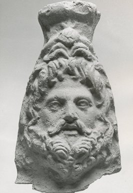  <em>Head of Serapis</em>, 2nd-3rd century C.E. Terracotta, 3 3/8 x 1 7/8 x 1 5/8 in. (8.5 x 4.8 x 4.1 cm). Brooklyn Museum, Gift of Evangeline Wilbour Blashfield, Theodora Wilbour, and Victor Wilbour honoring the wishes of their mother, Charlotte Beebe Wilbour, as a memorial to their father, Charles Edwin Wilbour, 16.224. Creative Commons-BY (Photo: Brooklyn Museum, CUR.16.224_NegA_print_bw.jpg)