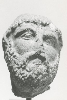 Graeco-Egyptian. <em>Male Portrait Head</em>, 3rd-2nd century B.C.E. Terracotta, 2 x 1 1/2 x 1 9/16 in. (5.1 x 3.8 x 3.9 cm). Brooklyn Museum, Gift of Evangeline Wilbour Blashfield, Theodora Wilbour, and Victor Wilbour honoring the wishes of their mother, Charlotte Beebe Wilbour, as a memorial to their father, Charles Edwin Wilbour, 16.234. Creative Commons-BY (Photo: Brooklyn Museum, CUR.16.234_NegC_print_bw.jpg)