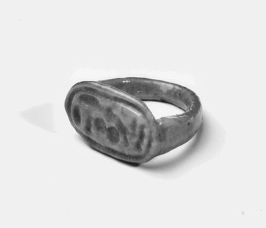  <em>Finger Ring with Cartouche of Akhenaten</em>, ca. 1353–1336 B.C.E. Faience, Diam. 13/16 x Length of bezel 11/16 in. (2 x 1.8 cm). Brooklyn Museum, Gift of Evangeline Wilbour Blashfield, Theodora Wilbour, and Victor Wilbour honoring the wishes of their mother, Charlotte Beebe Wilbour, as a memorial to their father, Charles Edwin Wilbour, 16.253. Creative Commons-BY (Photo: Brooklyn Museum, CUR.16.253_NegA_print_bw.jpg)