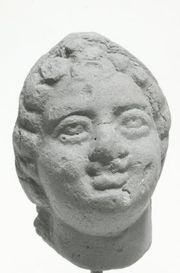  <em>Head or Mask</em>, 3rd century C.E. or later. Terracotta, 2 3/8 x 1 5/8 x 1 in. (6.1 x 4.2 x 2.6 cm). Brooklyn Museum, Gift of Evangeline Wilbour Blashfield, Theodora Wilbour, and Victor Wilbour honoring the wishes of their mother, Charlotte Beebe Wilbour, as a memorial to their father, Charles Edwin Wilbour, 16.299. Creative Commons-BY (Photo: Brooklyn Museum, CUR.16.299_NegA_print_bw.jpg)