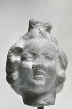 Graeco-Egyptian. <em>Head of a Child</em>. Terracotta, 1 3/4 x 1 1/4 x 1 3/8 in. (4.5 x 3.2 x 3.6 cm). Brooklyn Museum, Gift of Evangeline Wilbour Blashfield, Theodora Wilbour, and Victor Wilbour honoring the wishes of their mother, Charlotte Beebe Wilbour, as a memorial to their father, Charles Edwin Wilbour, 16.307. Creative Commons-BY (Photo: Brooklyn Museum, CUR.16.307_NegD_print_bw.jpg)