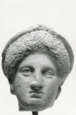 Greek. <em>Female Head</em>, late 5th to 4th century B.C.E. Clay, pigment, 1 5/16 x 1 1/8 x 1 in. (3.4 x 2.8 x 2.6 cm). Brooklyn Museum, Gift of Evangeline Wilbour Blashfield, Theodora Wilbour, and Victor Wilbour honoring the wishes of their mother, Charlotte Beebe Wilbour, as a memorial to their father, Charles Edwin Wilbour, 16.308. Creative Commons-BY (Photo: Brooklyn Museum, CUR.16.308_NegA_print_bw.jpg)