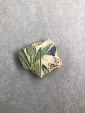  <em>Fragment of a Tile</em>, ca. 1352-1336 B.C.E. Faience, 3/8 × 1 7/16 × 1 9/16 in. (0.9 × 3.7 × 4 cm). Brooklyn Museum, Gift of Evangeline Wilbour Blashfield, Theodora Wilbour, and Victor Wilbour honoring the wishes of their mother, Charlotte Beebe Wilbour, as a memorial to their father, Charles Edwin Wilbour, 16.332. Creative Commons-BY (Photo: , CUR.16.332_view01.jpg)