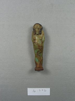  <em>Ushabti</em>, ca. 1075-656 B.C.E. Faience, 2 13/16 × 7/8 in. (7.2 × 2.2 cm). Brooklyn Museum, Gift of Evangeline Wilbour Blashfield, Theodora Wilbour, and Victor Wilbour honoring the wishes of their mother, Charlotte Beebe Wilbour, as a memorial to their father, Charles Edwin Wilbour, 16.373. Creative Commons-BY (Photo: Brooklyn Museum, CUR.16.373_front.jpg)