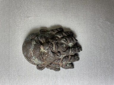 Graeco-Egyptian. <em>Silenus Mask</em>. Bronze, 2 3/4 × 2 × 13/16 in. (7 × 5.1 × 2 cm). Brooklyn Museum, Gift of Evangeline Wilbour Blashfield, Theodora Wilbour, and Victor Wilbour honoring the wishes of their mother, Charlotte Beebe Wilbour, as a memorial to their father, Charles Edwin Wilbour, 16.386. Creative Commons-BY (Photo: Brooklyn Museum, CUR.16.386_view01.jpg)
