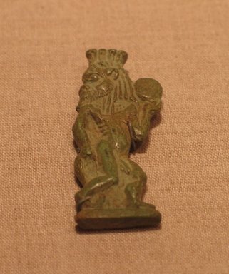  <em>Protective God as Dancer and Musician</em>, ca. 1390-1327 B.C.E. Faience, 1 11/16 x 11/16 in. (4.3 x 1.8 cm). Brooklyn Museum, Gift of Evangeline Wilbour Blashfield, Theodora Wilbour, and Victor Wilbour honoring the wishes of their mother, Charlotte Beebe Wilbour, as a memorial to their father, Charles Edwin Wilbour, 16.426. Creative Commons-BY (Photo: Brooklyn Museum, CUR.16.426_wwgA-2.jpg)