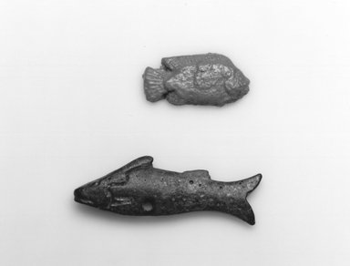  <em>Fish as Amulet</em>, ca. 1539–1075 B.C.E. Faience, 1/2 x 1 1/16 in. (1.3 x 2.7 cm). Brooklyn Museum, Gift of Evangeline Wilbour Blashfield, Theodora Wilbour, and Victor Wilbour honoring the wishes of their mother, Charlotte Beebe Wilbour, as a memorial to their father Charles Edwin Wilbour, 16.580.104. Creative Commons-BY (Photo: Brooklyn Museum, CUR.16.580.104_08.480.90_grpA_bw.jpg)