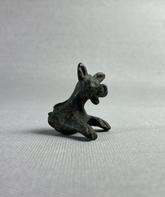  <em>Fragmentary Figure of a Dog</em>, 305 B.C.E.-395 C.E. Bronze, 1 3/8 × 1/2 × 1 1/16 in. (3.5 × 1.2 × 2.7 cm). Brooklyn Museum, Gift of Evangeline Wilbour Blashfield, Theodora Wilbour, and Victor Wilbour honoring the wishes of their mother, Charlotte Beebe Wilbour, as a memorial to their father, Charles Edwin Wilbour, 16.580.167. Creative Commons-BY (Photo: Brooklyn Museum, CUR.16.580.167_view01.jpg)
