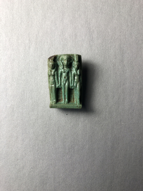  <em>Triad of Isis, Horus and Nephthys</em>, ca. 664–525 B.C.E. Faience, 1 × 11/16 × 3/8 in. (2.5 × 1.7 × 1 cm). Brooklyn Museum, Gift of Evangeline Wilbour Blashfield, Theodora Wilbour, and Victor Wilbour honoring the wishes of their mother, Charlotte Beebe Wilbour, as a memorial to their father, Charles Edwin Wilbour, 16.580.1. Creative Commons-BY (Photo: , CUR.16.580.1_view01.jpg)