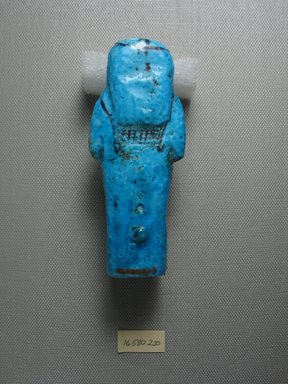  <em>Funerary Figurine of Djedptahiouefankh</em>, ca. 1190–945 B.C.E. Faience, 4 1/16 x 1 11/16 x 1 5/16 in. (10.3 x 4.3 x 3.3 cm). Brooklyn Museum, Gift of Evangeline Wilbour Blashfield, Theodora Wilbour, and Victor Wilbour honoring the wishes of their mother, Charlotte Beebe Wilbour, as a memorial to their father Charles Edwin Wilbour, 16.580.200. Creative Commons-BY (Photo: Brooklyn Museum, CUR.16.580.200_view4.jpg)