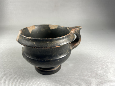Greek. <em>Cup on Hollow Foot</em>, 5th-4th century B.C.E. Clay, slip, 3 1/8 × 4 1/8 × 4 3/4 in. (8 × 10.5 × 12 cm). Brooklyn Museum, Gift of Evangeline Wilbour Blashfield, Theodora Wilbour, and Victor Wilbour honoring the wishes of their mother, Charlotte Beebe Wilbour, as a memorial to their father, Charles Edwin Wilbour, 16.580.231. Creative Commons-BY (Photo: Brooklyn Museum, CUR.16.580.231_view01.jpg)