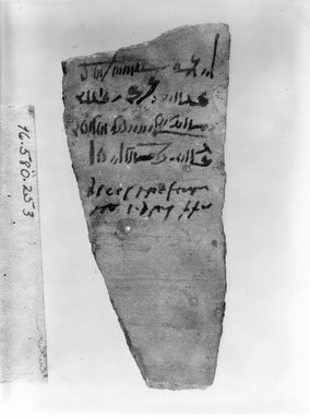  <em>Demotic Ostracon</em>, Year 38 of Augustus. Terracotta, pigment, 2 3/8 x 3/8 x 5 1/8 in. (6.1 x 1 x 13 cm). Brooklyn Museum, Gift of Evangeline Wilbour Blashfield, Theodora Wilbour, and Victor Wilbour honoring the wishes of their mother, Charlotte Beebe Wilbour, as a memorial to their father, Charles Edwin Wilbour, 16.580.253. Creative Commons-BY (Photo: Brooklyn Museum, CUR.16.580.253_NegA_bw.jpg)