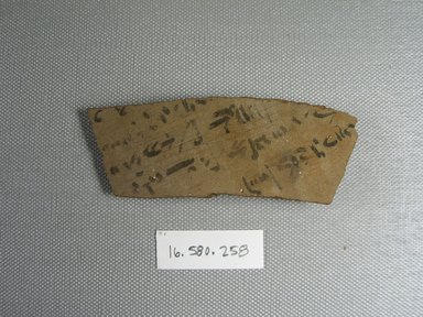  <em>Demotic Ostracon</em>. Terracotta, pigment, 1 1/2 x 1/4 x 3 7/8 in. (3.8 x 0.7 x 9.8 cm). Brooklyn Museum, Gift of Evangeline Wilbour Blashfield, Theodora Wilbour, and Victor Wilbour honoring the wishes of their mother, Charlotte Beebe Wilbour, as a memorial to their father, Charles Edwin Wilbour, 16.580.258. Creative Commons-BY (Photo: Brooklyn Museum, CUR.16.580.258_view1.jpg)