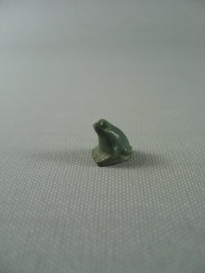  <em>Figure of a Seated Frog as Amulet</em>. Feldspar (?), 9/16 x 3/8 x 1/2 in. (1.4 x 0.9 x 1.3 cm). Brooklyn Museum, Gift of Evangeline Wilbour Blashfield, Theodora Wilbour, and Victor Wilbour honoring the wishes of their mother, Charlotte Beebe Wilbour, as a memorial to their father Charles Edwin Wilbour, 16.580.64. Creative Commons-BY (Photo: Brooklyn Museum, CUR.16.580.64_View1.jpg)