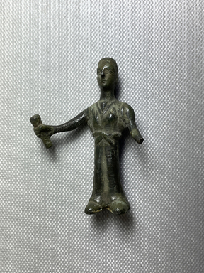 Etruscan. <em>Statuette of a Standing Woman</em>. Bronze, 2 11/16 × 1 15/16 × 1 1/4 in. (6.8 × 5 × 3.2 cm). Brooklyn Museum, Gift of Evangeline Wilbour Blashfield, Theodora Wilbour, and Victor Wilbour honoring the wishes of their mother, Charlotte Beebe Wilbour, as a memorial to their father, Charles Edwin Wilbour, 16.580.85. Creative Commons-BY (Photo: Brooklyn Museum, CUR.16.580.85_view01.jpg)