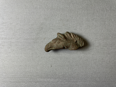  <em>Head of a Griffin</em>, 2nd century C.E. (probably). Terracotta, pigment, 7/8 × 5/8 × 1 15/16 in. (2.3 × 1.6 × 4.9 cm). Brooklyn Museum, Gift of Evangeline Wilbour Blashfield, Theodora Wilbour, and Victor Wilbour honoring the wishes of their mother, Charlotte Beebe Wilbour, as a memorial to their father, Charles Edwin Wilbour, 16.625. Creative Commons-BY (Photo: Brooklyn Museum, CUR.16.625_view01.jpg)