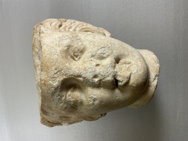 Roman (?). <em>Head of a Satyr</em>, ca. 150-200 C.E. Marble, 7 7/8 × 6 7/8 × 6 11/16 in. (20 × 17.5 × 17 cm). Brooklyn Museum, Gift of Evangeline Wilbour Blashfield, Theodora Wilbour, and Victor Wilbour honoring the wishes of their mother, Charlotte Beebe Wilbour, as a memorial to their father, Charles Edwin Wilbour, 16.630. Creative Commons-BY (Photo: Brooklyn Museum, CUR.16.630_view01.jpg)