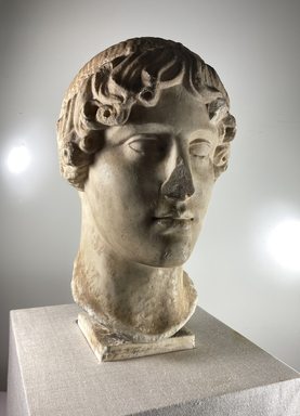 Roman. <em>Head, Apollo of the Omphalos</em>, 1st century C.E. copy of a 480 B.C.E. original. Marble, 12 5/8 × 7 7/8 × 9 1/16 in. (32 × 20 × 23 cm). Brooklyn Museum, Purchased with funds given by A. Augustus Healy and Robert B. Woodward Memorial Fund, 18.166. Creative Commons-BY (Photo: Brooklyn Museum, CUR.18.166_view01-1.jpg)