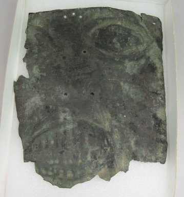  <em>[Illegible] Mask, Found with Mummies</em>. Metal, 6 5/8 x 5 1/2 in. (16.8 x 14 cm). Brooklyn Museum, Gift of Richard H. Clarke, 1864. Creative Commons-BY (Photo: Brooklyn Museum, CUR.1864.jpg)