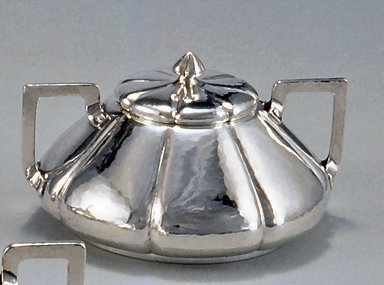 Shreve & Company (founded 1852). <em>Sugar Bowl and Lid, from Three Piece Tea Service</em>, ca. 1910. Silver, wood, 3 3/8 x 6 1/8 x 5 1/2 in. (8.6 x 15.6 x 14 cm). Brooklyn Museum, Gift of Mr. and Mrs. Daniel L. Silberberg, by exchange, 1989.22.3a-b. Creative Commons-BY (Photo: Brooklyn Museum, CUR.1989.22.3a-b.jpg)