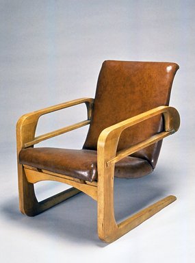 Kem Weber (American, born Germany, 1889-1963). <em>Armchair ("Airline Chair")</em>, 1934-1935. Wood, Naugahyde, leather, metal, 34 1/4 x 25 x 34 1/2 in. (87 x 63.5 x 87.6 cm). Brooklyn Museum, Modernism Benefit Fund, 1991.104. Creative Commons-BY (Photo: Brooklyn Museum, CUR.1991.104.jpg)