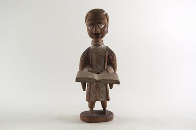 Thomas Ona Odulate (Yorùbá, Nigerian, ca. 1900-1952). <em>Figure of a Clergyman</em>, early 20th century. Wood, pigment, 9 3/16 x 3 1/4 in. (23.2 x 8.2 cm). Brooklyn Museum, Caroline H. Polhemus Fund, 1991.175.2. Creative Commons-BY (Photo: Brooklyn Museum, CUR.1991.175.2_front_PS5.jpg)