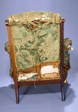 Pottier & Stymus Manufacturing Company (United States, New York, active ca. 1859-1910). <em>Armchair (Egyptian Revival style)</em>, ca. 1870. Rosewood, burl walnut, gilt and patinated metal mounts, original upholstery, 38 1/4 x 30 x 29 in.  (97.2 x 76.2 x 73.7 cm). Brooklyn Museum, Bequest of Marie Bernice Bitzer, by exchange and anonymous gift, 1992.89. Creative Commons-BY (Photo: Brooklyn Museum, CUR.1992.89_back.jpg)