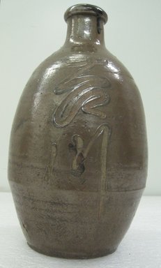 <em>Tamba Ware Tokkuri</em>, 19th century. Buff stoneware, brown glaze, height: 10 in. Brooklyn Museum, Gift of Dr. and Mrs. John P. Lyden, 1993.194.9. Creative Commons-BY (Photo: Brooklyn Museum, CUR.1993.194.9_side_view1.jpg)